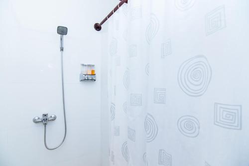 a shower with a shower head in a bathroom at Luang Prabang Legend Hotel in Luang Prabang