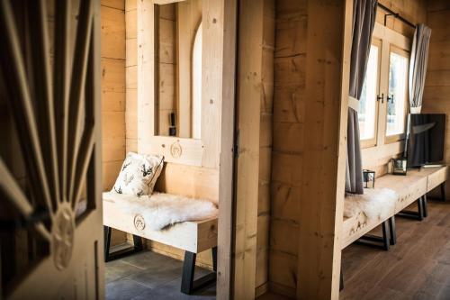 a room with benches in a wooden cabin with windows at Osada domków TATRA-DREAM in Zakopane