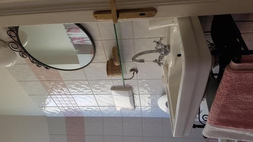 a bathroom with a mirror and a toilet at Lido di Ostia 1933 in Lido di Ostia