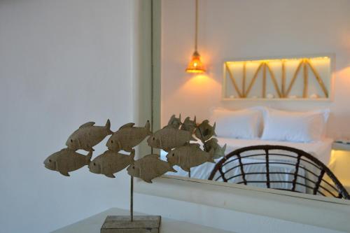 a room with a mirror and a bed in a room at Hawk Stone in Adamas
