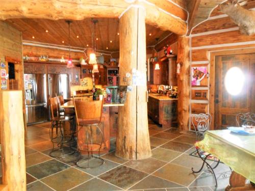 a kitchen with a table and chairs in a room at McDonald's Ranch Lodge in Gardiner
