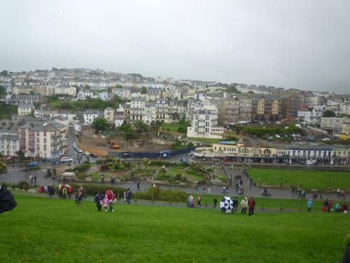 a group of people walking around a park in a city at Varley House in Ilfracombe