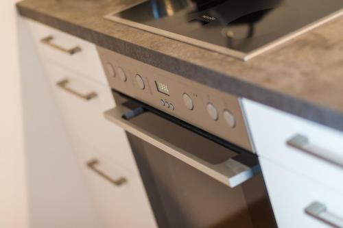 a kitchen with a stove and a counter top at Appartement Auszeit in Sankt Michael im Lungau