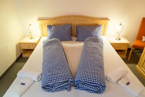 a bed with checkered pillows on top of it at Ferienhaus Panorama in Biberwier