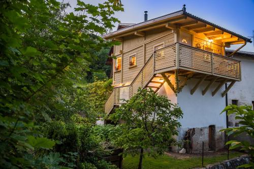 a tree house with a balcony on the side of a house at House Gabrijel with four seasons outdoor kitchen in Bled
