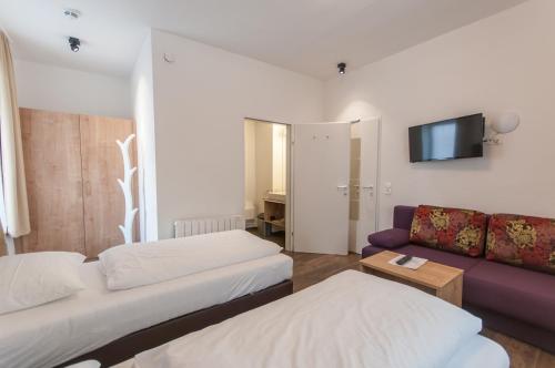 Ein Bett oder Betten in einem Zimmer der Unterkunft Pension Max SUMMERCARD INCLUDED