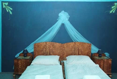 a blue bedroom with a bed with a blue ceiling at Penzion Haberský vrch in Habří