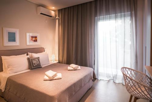 a bedroom with a bed with two towels on it at Elegant House Under Acropolis in Athens