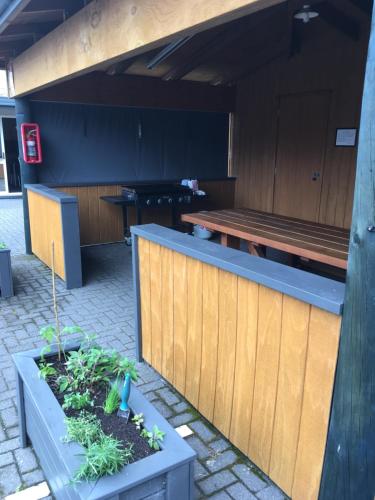 a patio with a bench and a table at Capri on Fenton in Rotorua