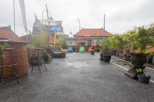 a patio with plants and a star on the ground at Poshtel Ubud in Ubud