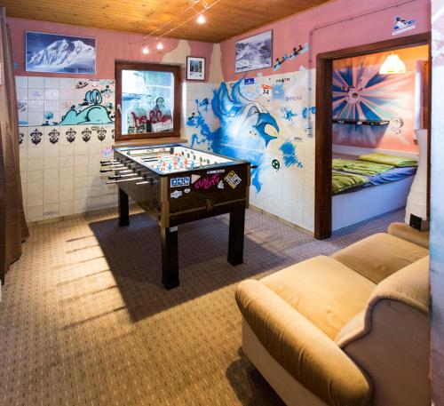 a room with a foosball table and a bedroom at Ridehouse in Schladming