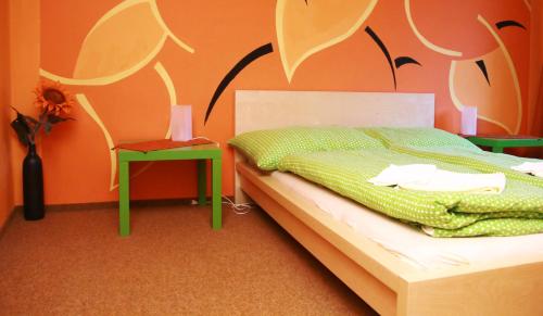a bedroom with a bed and a table and a chair at Penzion Haberský vrch in Habří
