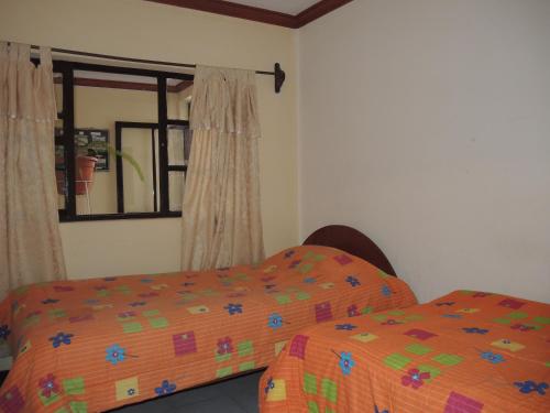 Ένα ή περισσότερα κρεβάτια σε δωμάτιο στο Hostal Valle Hermoso