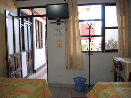 Ένα ή περισσότερα κρεβάτια σε δωμάτιο στο Hostal Valle Hermoso