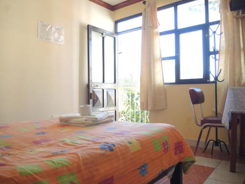 Ένα ή περισσότερα κρεβάτια σε δωμάτιο στο Hostal Valle Hermoso