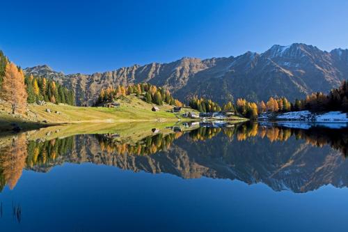 a reflection of a mountain in a lake at Ridehouse in Schladming