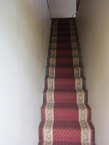 an ascending staircase with red and white carpet at Sorell Barracks in Sorell