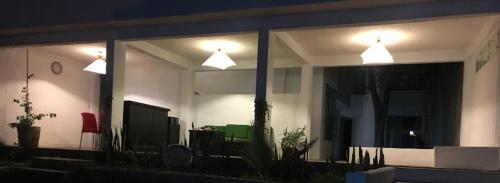 a house with two lights on the windows at night at El Arrayan in Valle de Bravo