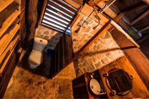 an overhead view of a bathroom with a toilet and a window at Escarabajo Rojo in Tulum