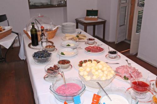 a table with many bowls and plates of food at Osteria Locanda Brack in Gudo