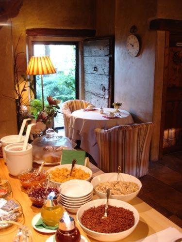 a table with bowls and plates of food on it at Hotel L'Ultimo Mulino in Bannia
