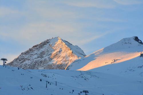 a snow covered mountain with the sun shining on it at Ferienwohnung Schweng in Tux