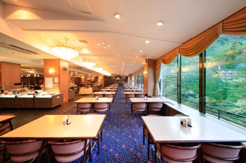 a row of tables and chairs in a restaurant at Hotel Okada in Hakone