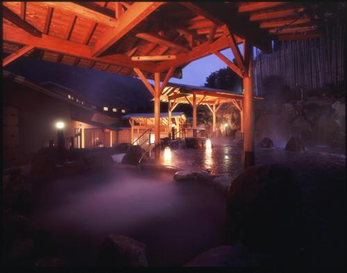 a covered patio at night with lights at Hotel Okada in Hakone