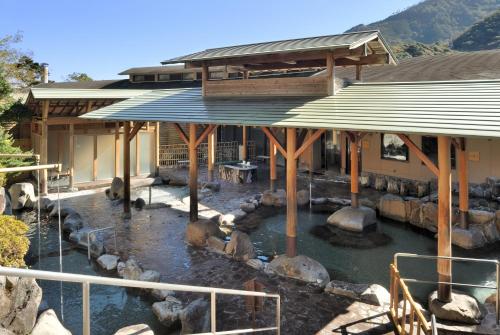 a building with a pool of water in front of it at Hotel Okada in Hakone