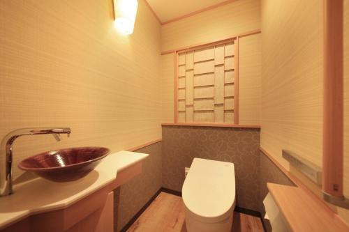 a bathroom with a sink and a toilet at Hotel Okada in Hakone