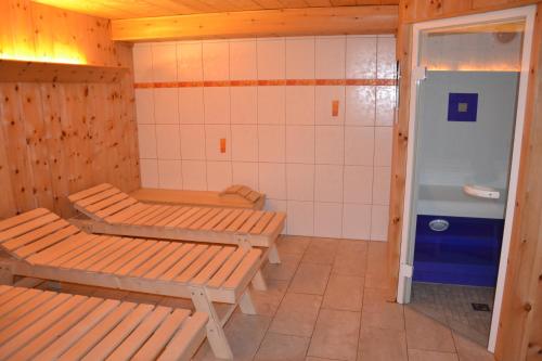 a bathroom with two benches and a shower at Holiday-Appartements in Flachau