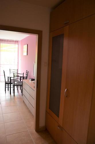 a kitchen and dining room with a table and chairs at Vadszilva Apartman in Balatonőszöd