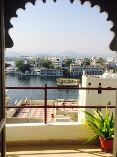a view of the water from a balcony at Peacock Guest House - Lake View Hotel In Udaipur in Udaipur