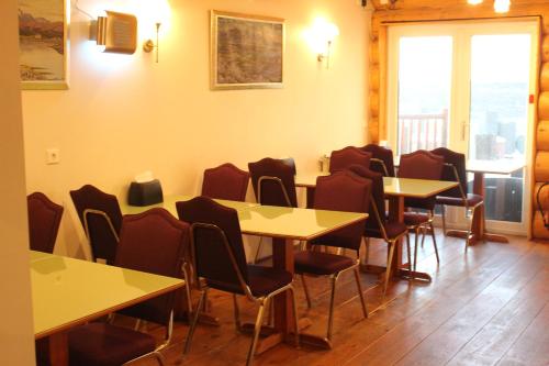 a dining room table with chairs and tables at Welcome Lambafell in Eyvindarhólar