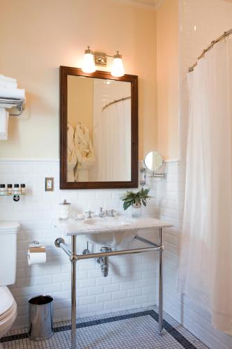 a bathroom with a sink and a mirror at New Sheridan Hotel in Telluride