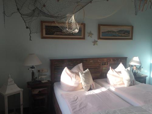 a bedroom with a bed with white sheets and pillows at Hotel Trendtino in Eisenberg