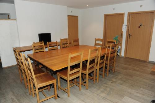 a large wooden table and chairs in a room at Hotel Restaurant Au Chasseur in Orbe