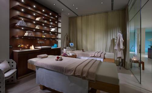 a bedroom with two beds and a bathroom at Principe Forte Dei Marmi - Resort & Spa in Forte dei Marmi