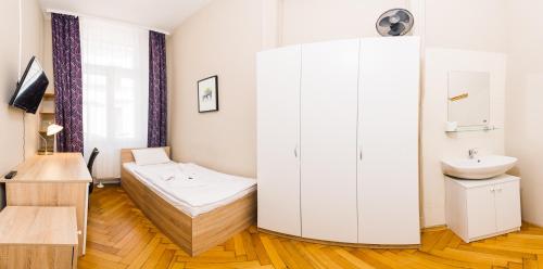 a bathroom with a bed and a sink in a room at Centric Lifestyle Apartments in Budapest