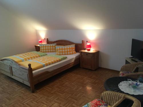 a bedroom with a bed and a table and a television at Reiterhof Rössler in Poppendorf im Burgenland
