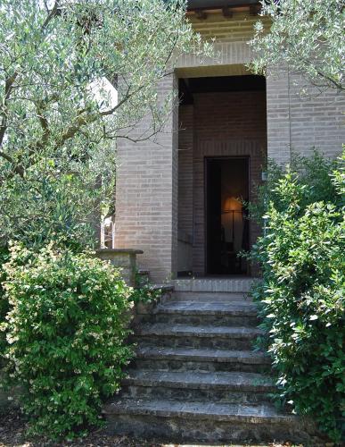 a brick building with stairs leading to a door at Il Poggio degli Olivi in Bettona