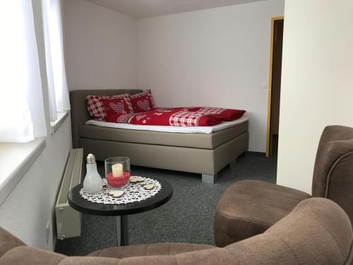 a room with a bed and two chairs and a table at Berggasthaus First - Only Accessible by Cable Car in Grindelwald