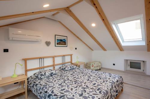 a bedroom with a bed in a attic at Apartments Villa Adrienne in Mali Lošinj