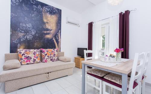 a living room with a couch and a table at Apartments Matea in Baška