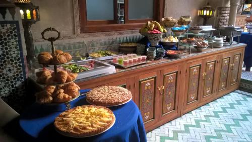 a buffet with many different types of bread and pastries at Riad Palais Sebban in Marrakech
