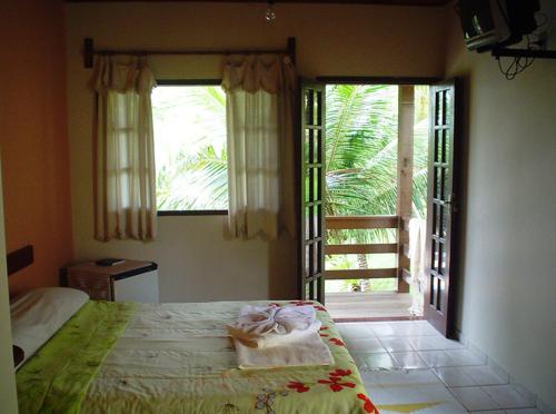 A bed or beds in a room at Pousada Lagoa da Mata