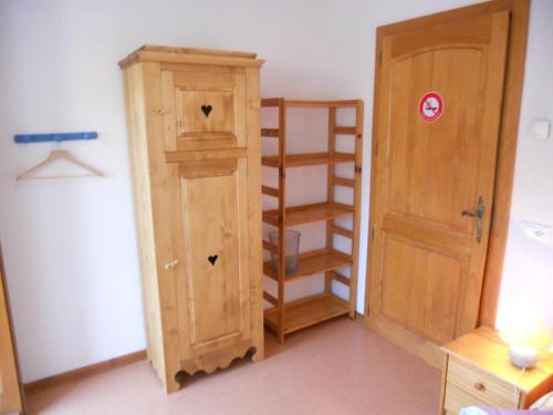 a room with a book shelf and a wooden cabinet at Auberge du Saut des Cuves in Xonrupt-Longemer