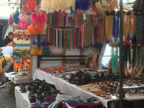 a market with a display of beads and other items at Hostal y Complejo Recreacional La Playita de Monse in Otavalo