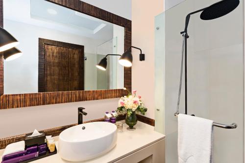 a bathroom with a sink and a mirror at Beach Walk Boutique Jumeirah in Dubai