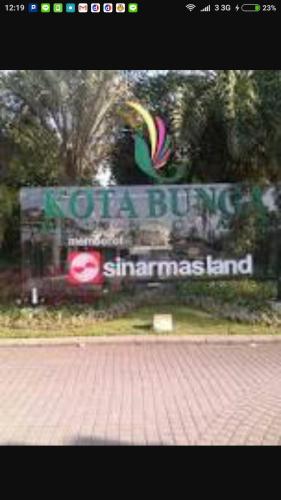 a sign for a building with a rainbow on it at Vila Kota Bunga Private Pool in Puncak